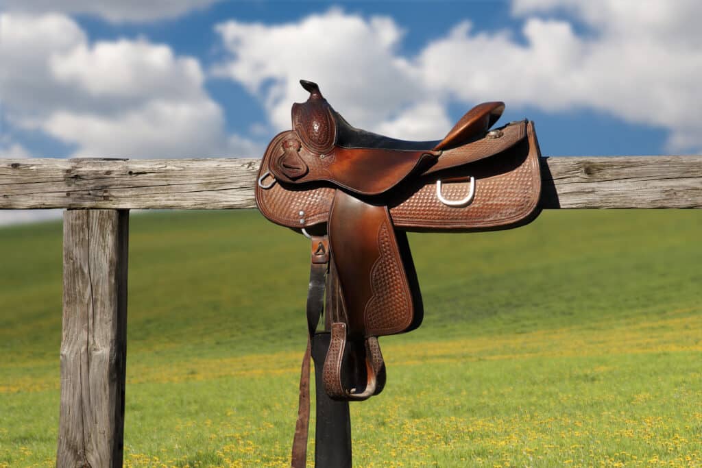 Horse saddle on rural fence